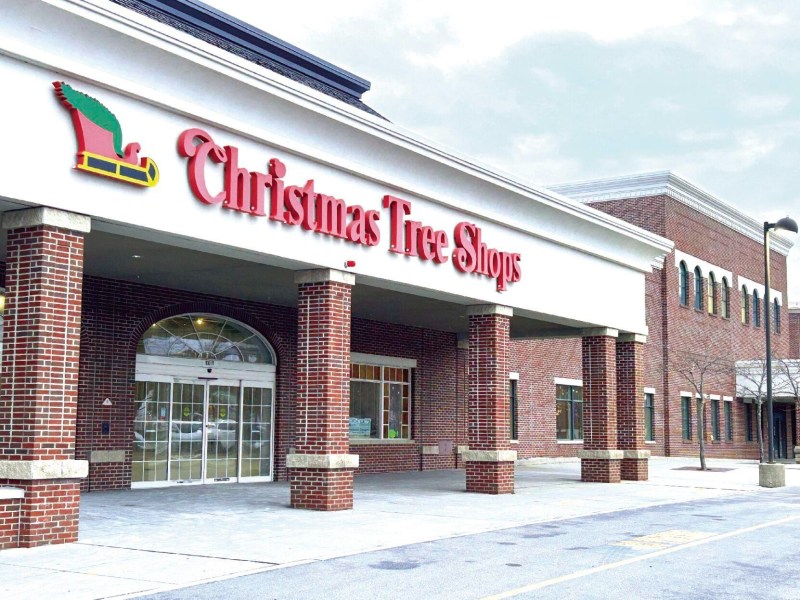 Exterior of a brick building with a sign reading "Christmas Tree Shops" above the entrance.
