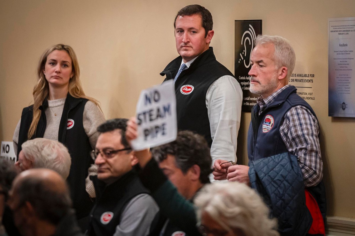 A group of people holding signs in front of a room.
