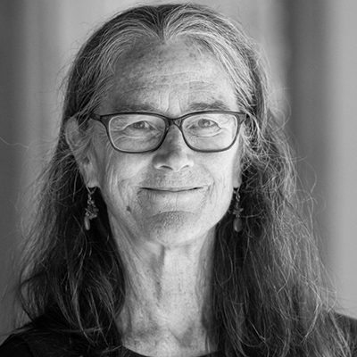 A black and white photo of a woman with glasses.