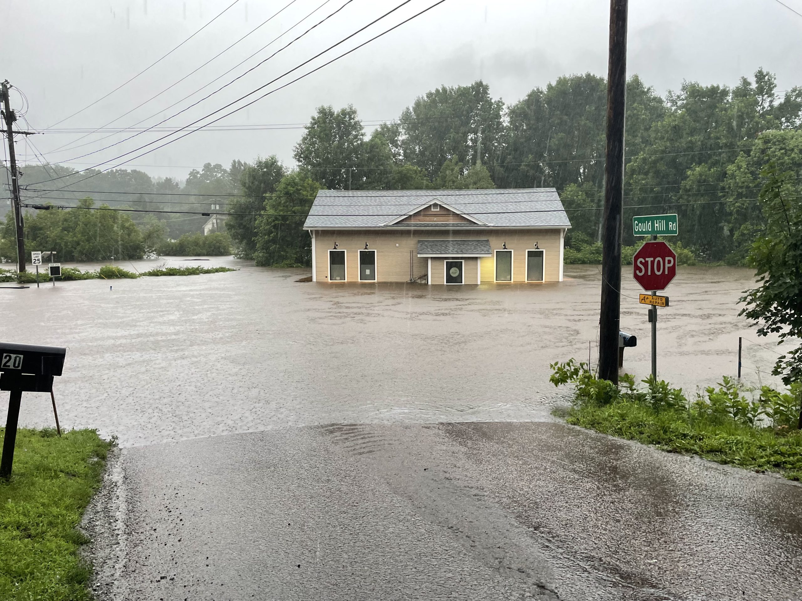A beige building surrounded by floodwaters.