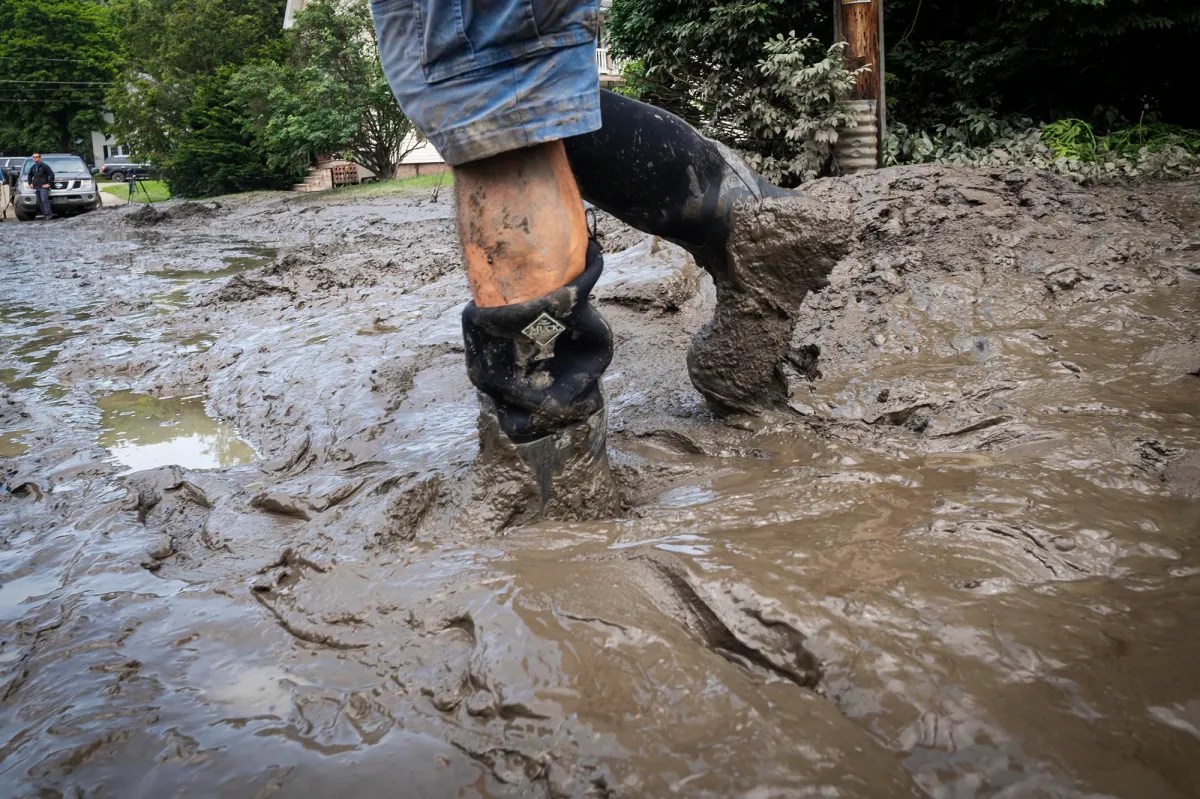a person standing in a muddy puddle.