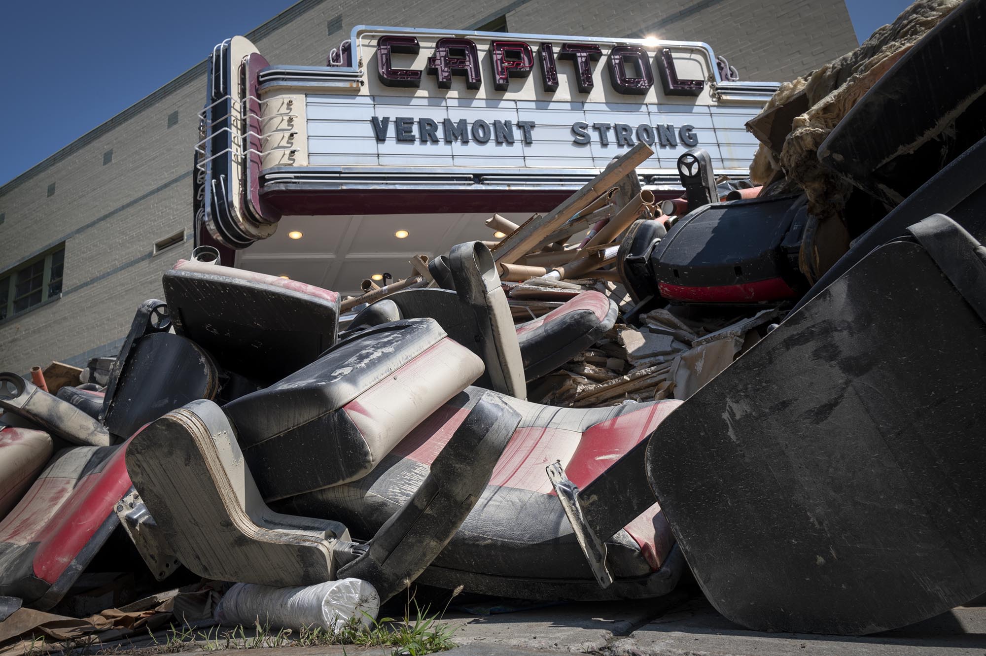 a pile of chairs in front of a building.