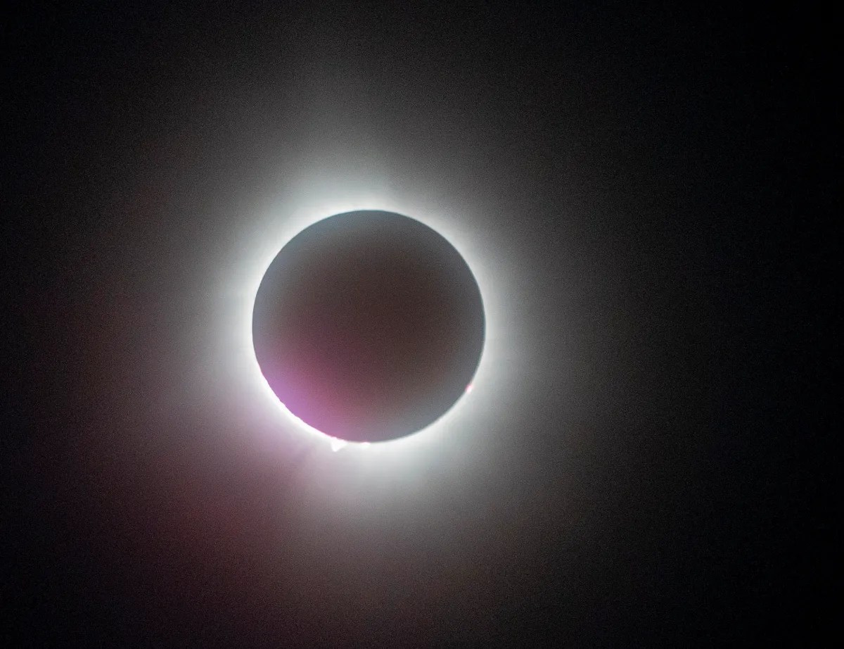 Total solar eclipse with a diamond ring effect visible.