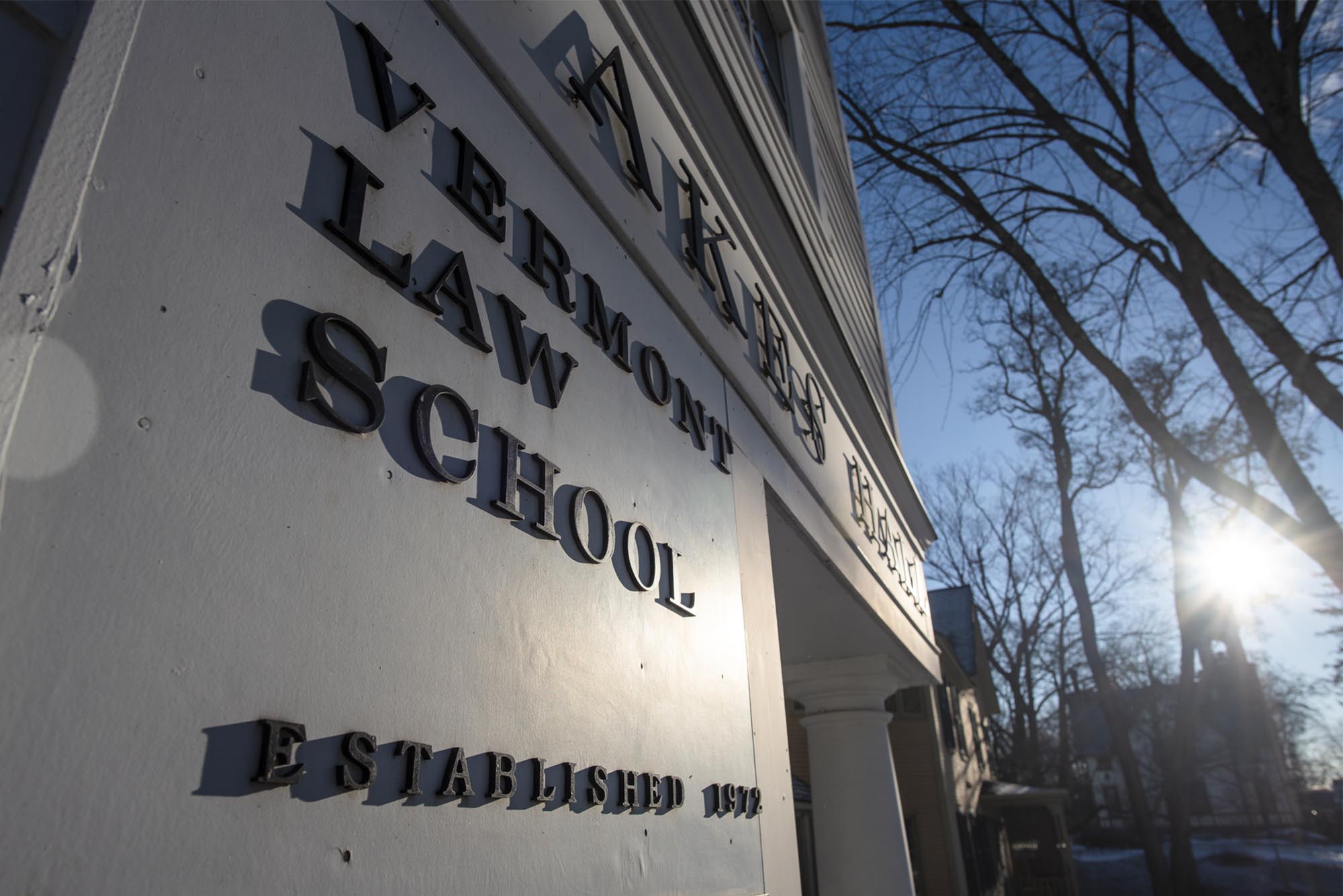 A white sign with black letters for Vermont Law School.